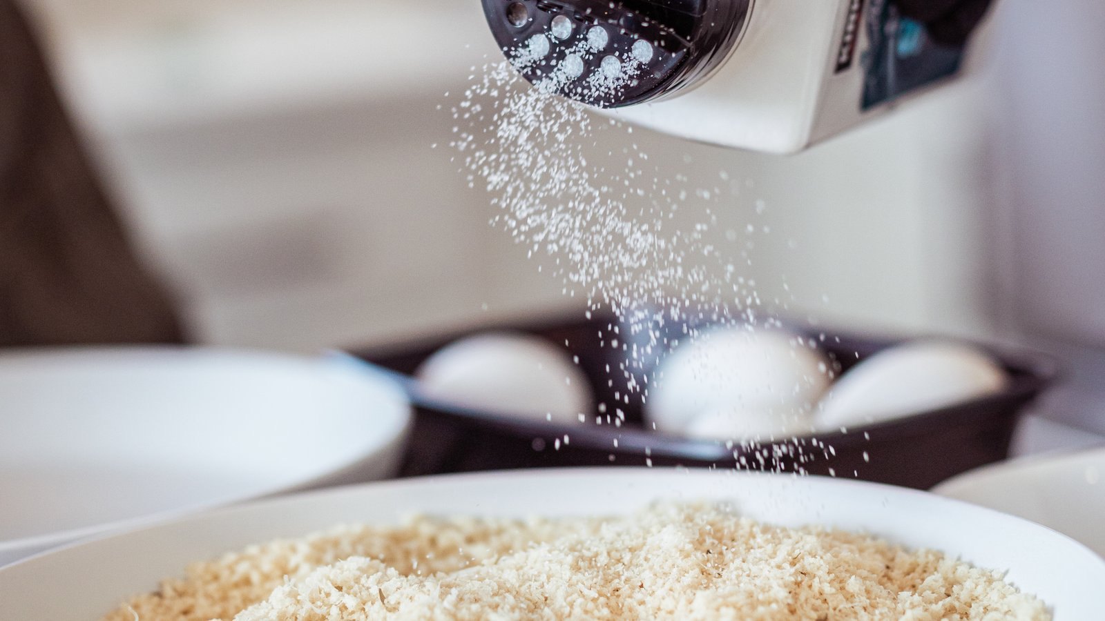 Chef seasoning a dish