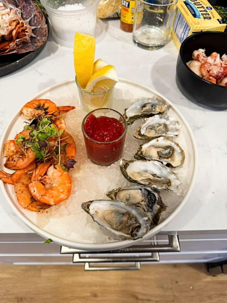 Seafood tower with oysters and poached shrimp on ice
